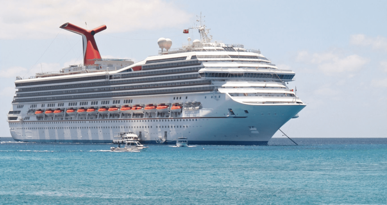 Cruise ship on ocean with small boats.