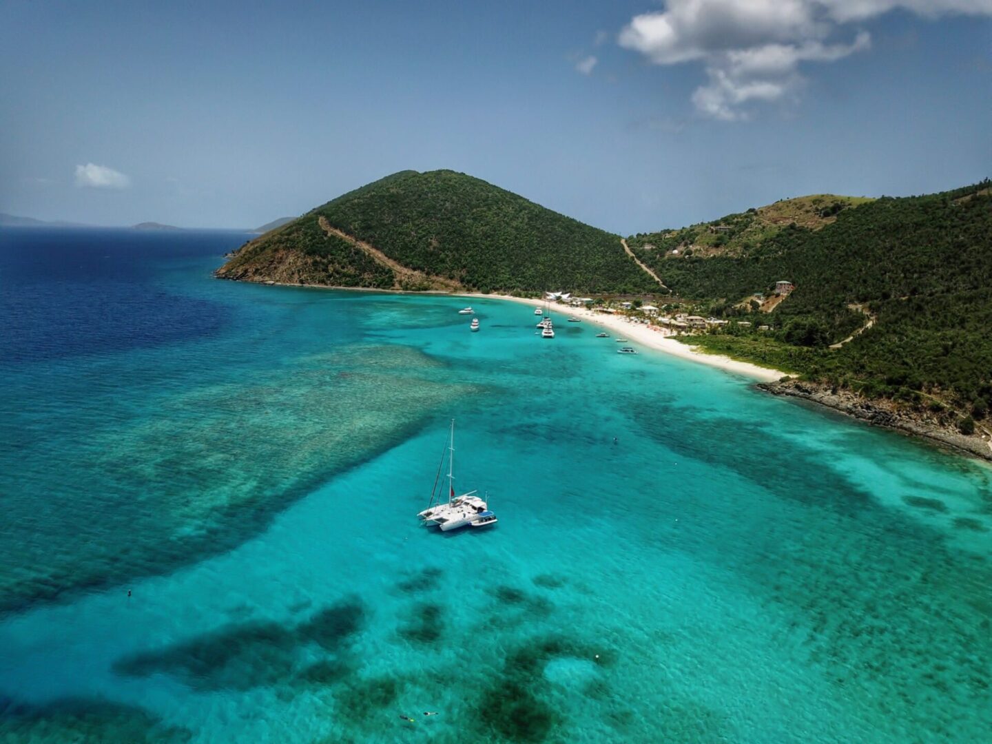 Turquoise sea with boats near tropical island.