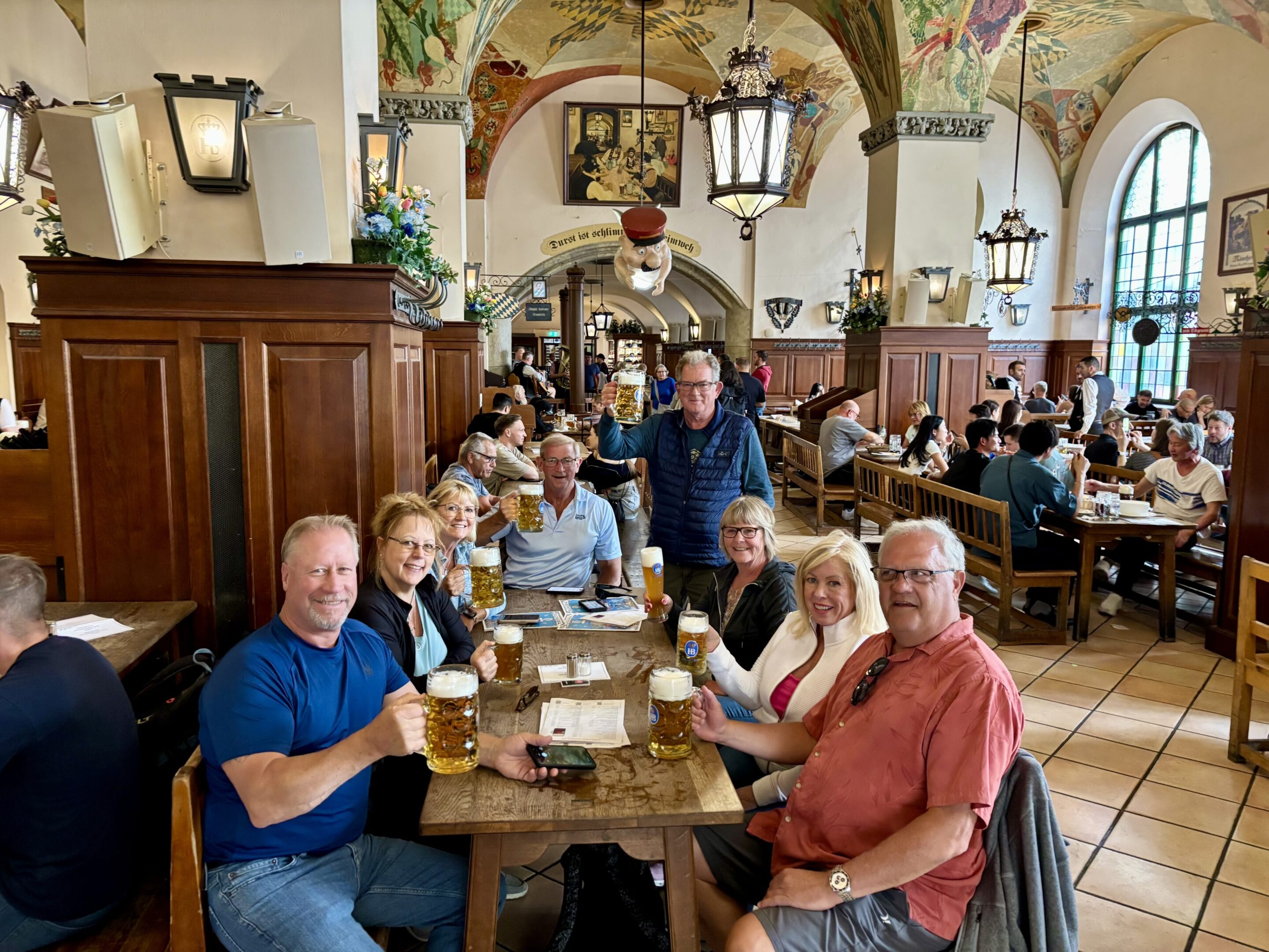 A group enjoying drinks together in a lively pub.