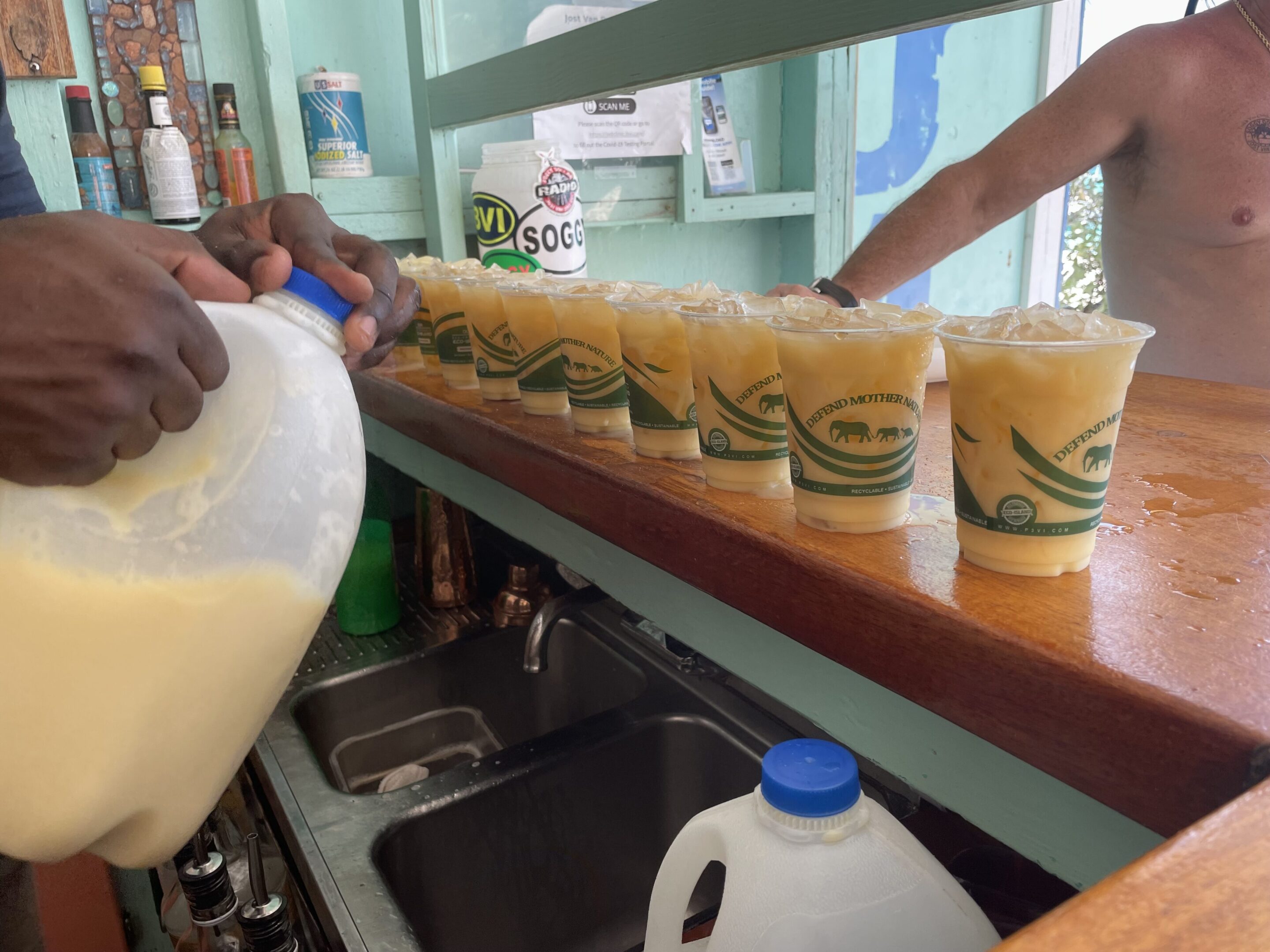 Row of cups filled with a creamy beverage on a counter.